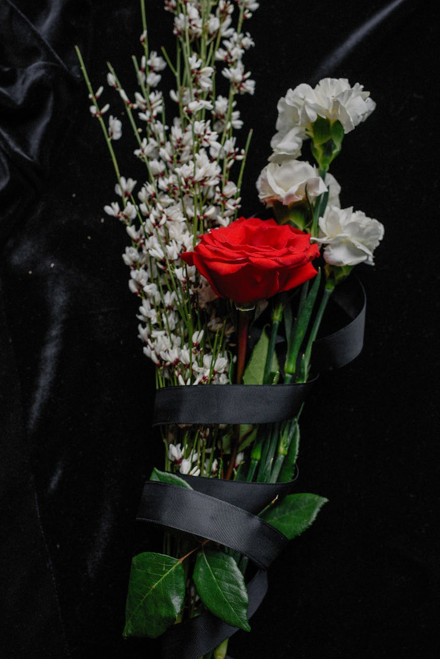 a flower bouquet wrapped in black ribbon