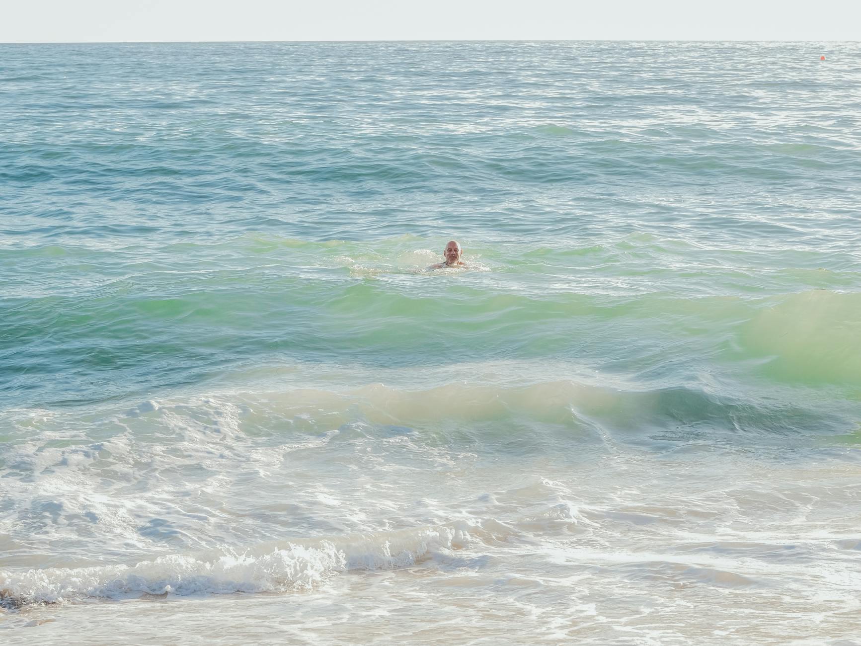 a man swimming in sea water