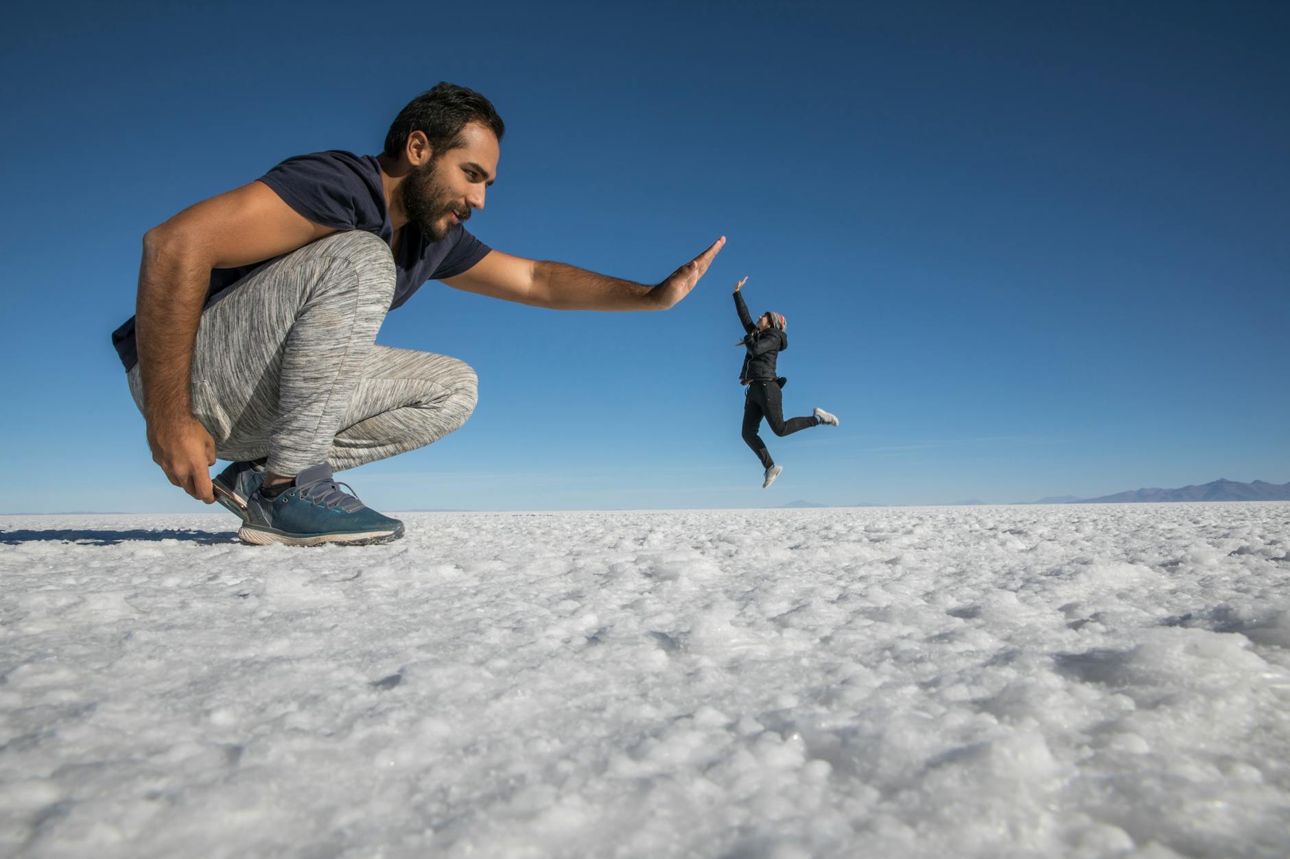 funny perspective photo of man and woman giving high five